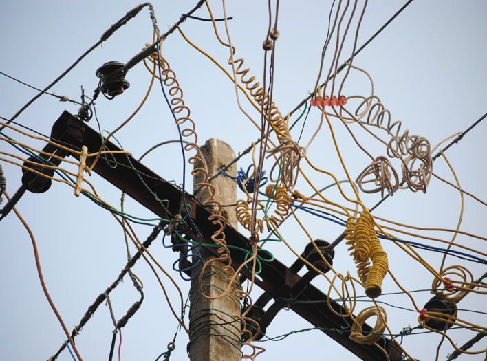 utility pole with crazy wires